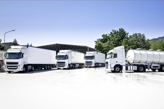 Trucks with semi-trailers and a tanker at a logistics base